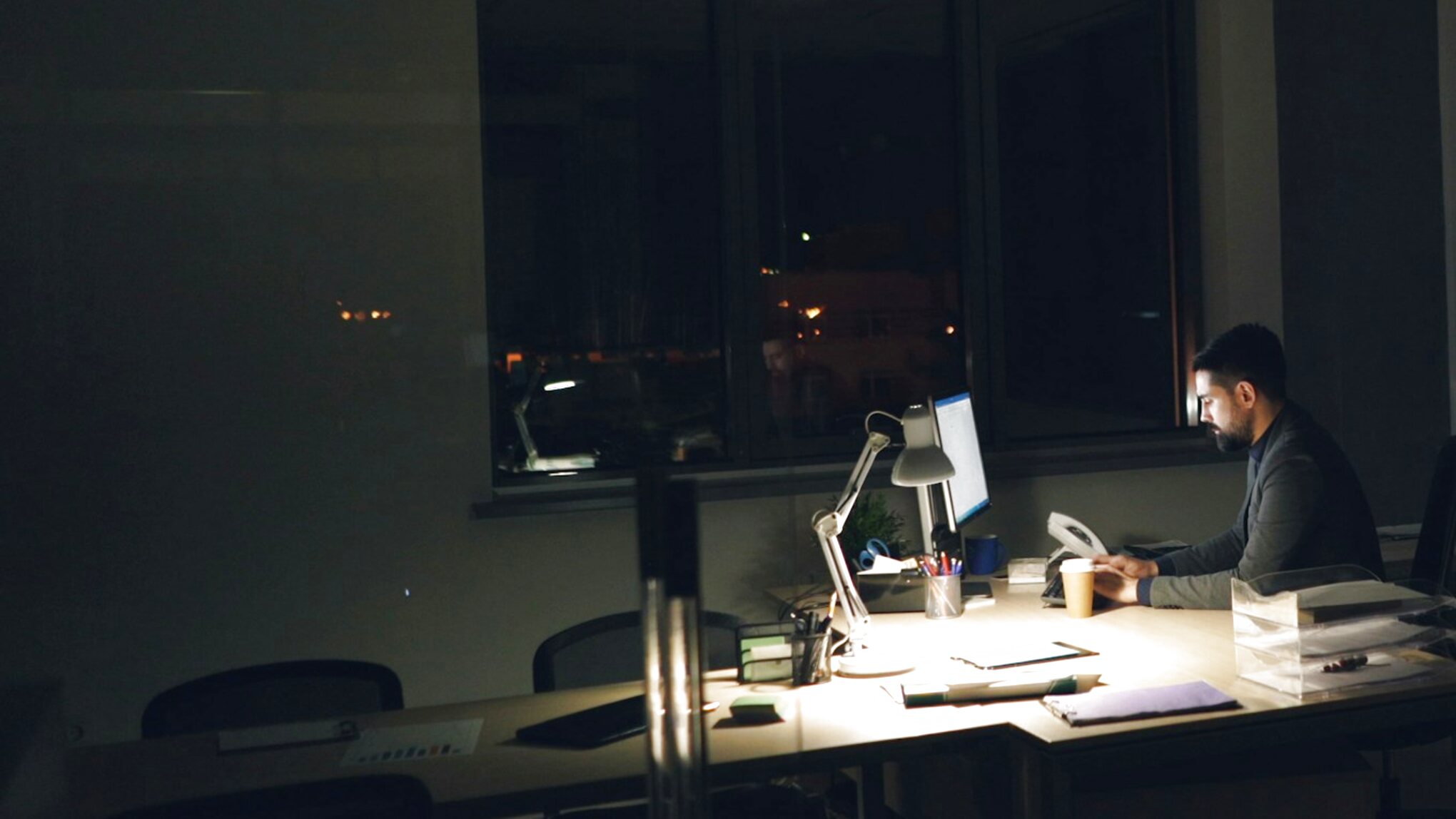 Person working at a desk after dark